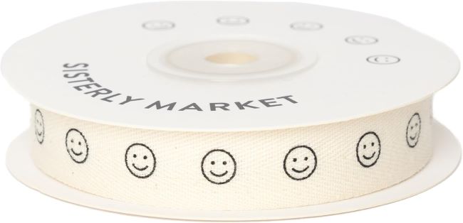 Natural herringbone cotton ribbon with smiley face print, ideal for gift wrapping, DIY crafts, and decorative projects.