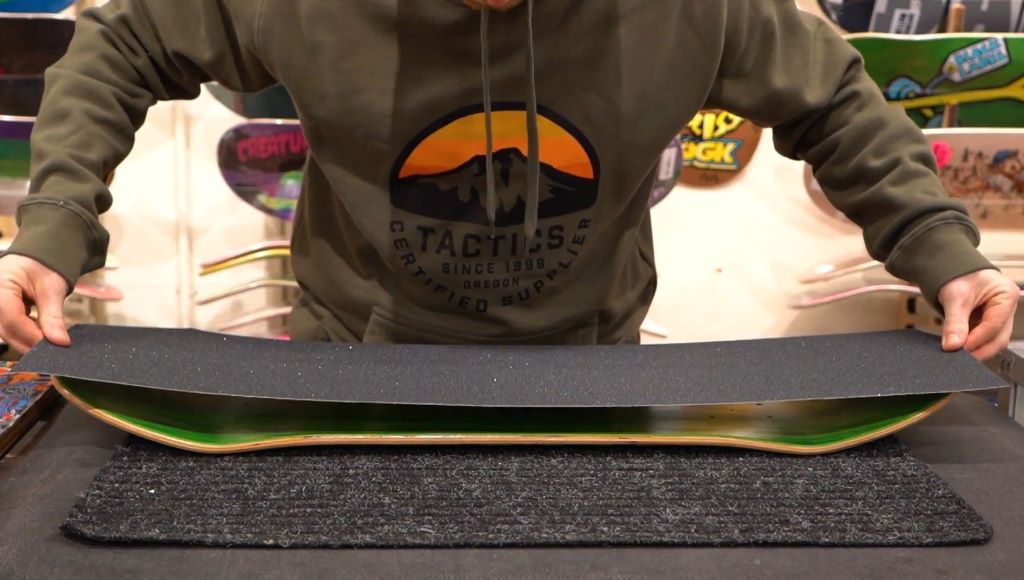 Skateboard deck with textured grip tape designed for enhanced control during tricks and turns