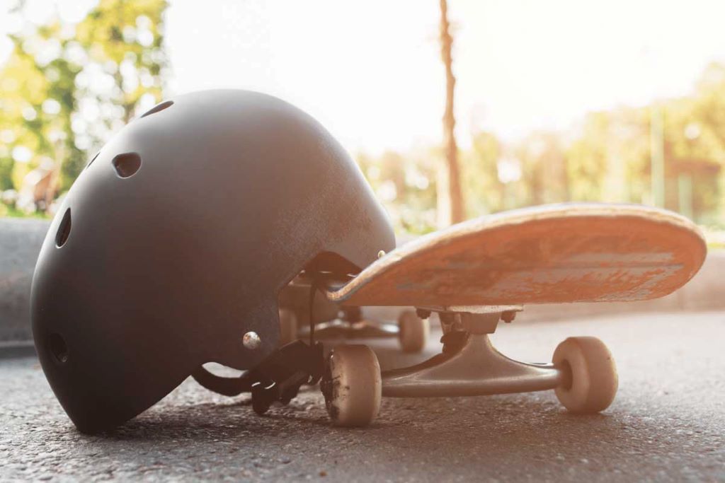Skater riding with a safety helmet emphasizing protection during skateboarding activities