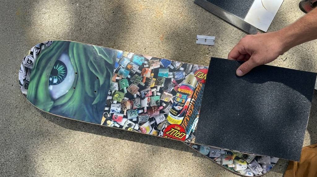Removing air bubbles from skateboard grip tape installation
