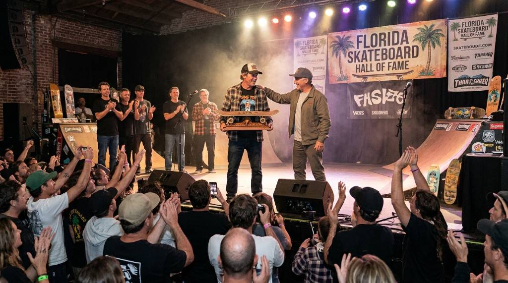 Crowd cheering as an inductee receives an award on stage at a Florida skate ceremony